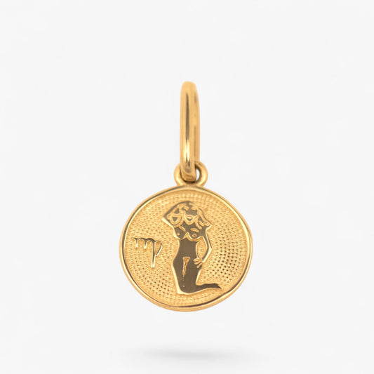 Pandantiv cu zodia fecioara din aur de 14k pe fundal alb. 14k solid gold 
Virgo zodiac charm on a white background